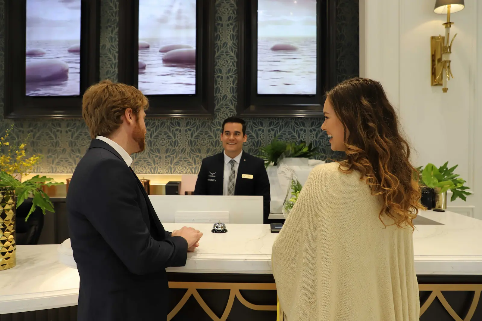 A Condor Concierge professional welcoming residents at a luxury condominium front desk